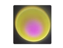 Circular lens or filter with yellow rim and pink center on a black background