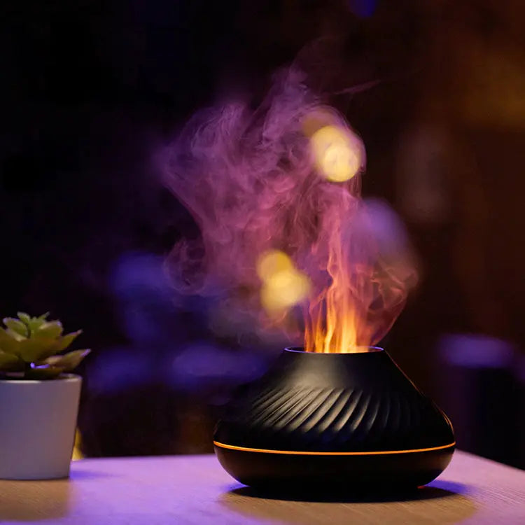 Black essential oil diffuser with colorful mist on a dark background