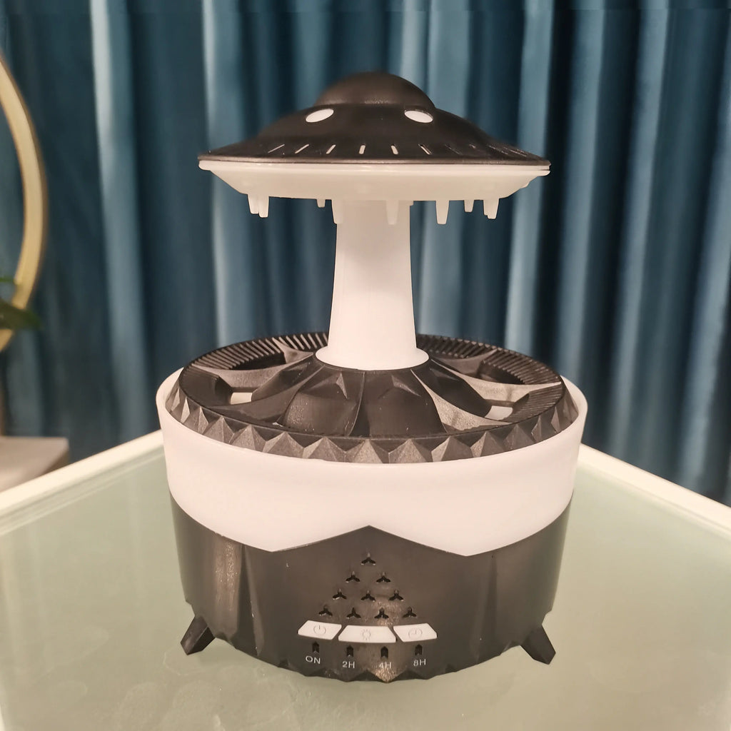 Black and white UFO-shaped lamp on a reflective surface with a blue curtain background