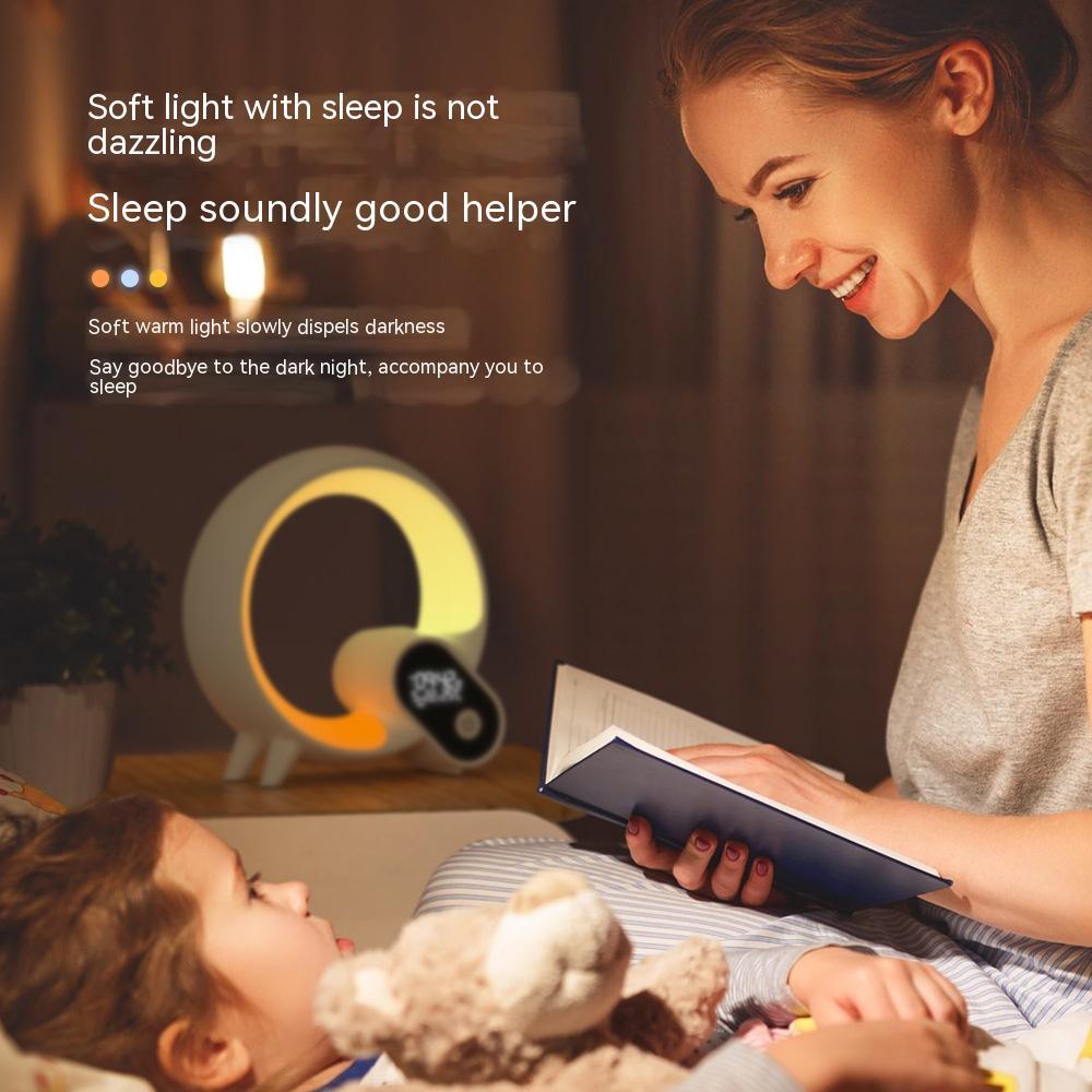 Woman reading a book to a child in a cozy room with soft lighting.