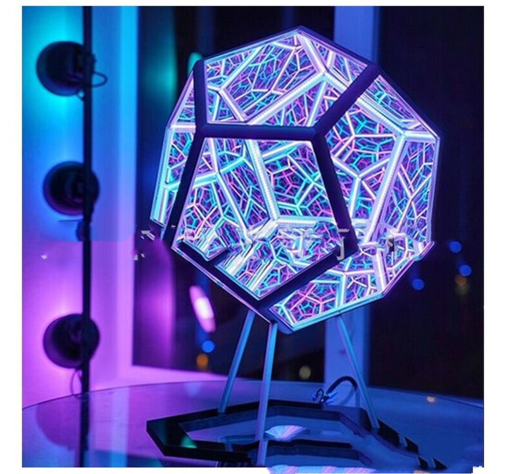 Geometric LED lamp with colorful design on a stand against a dark background