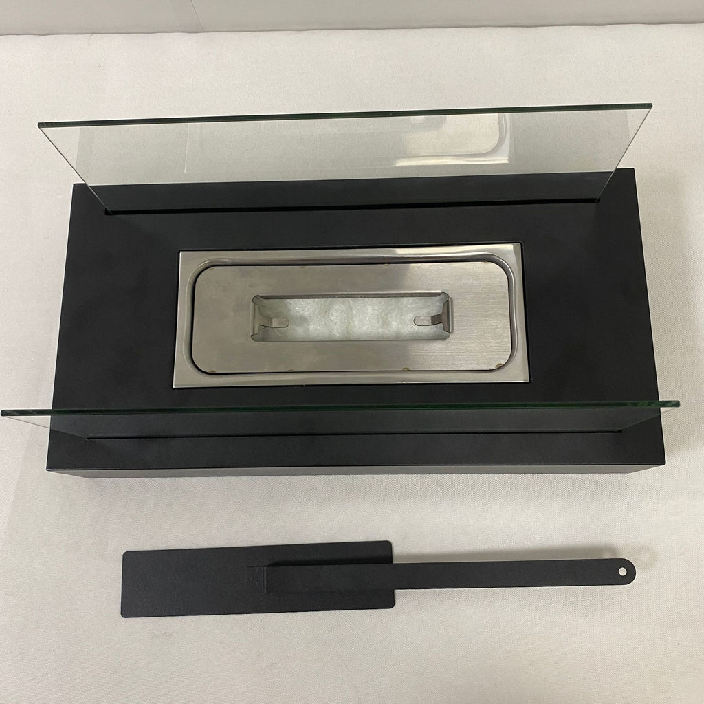 Modern wall-mounted fireplace with glass cover and black base on a white background