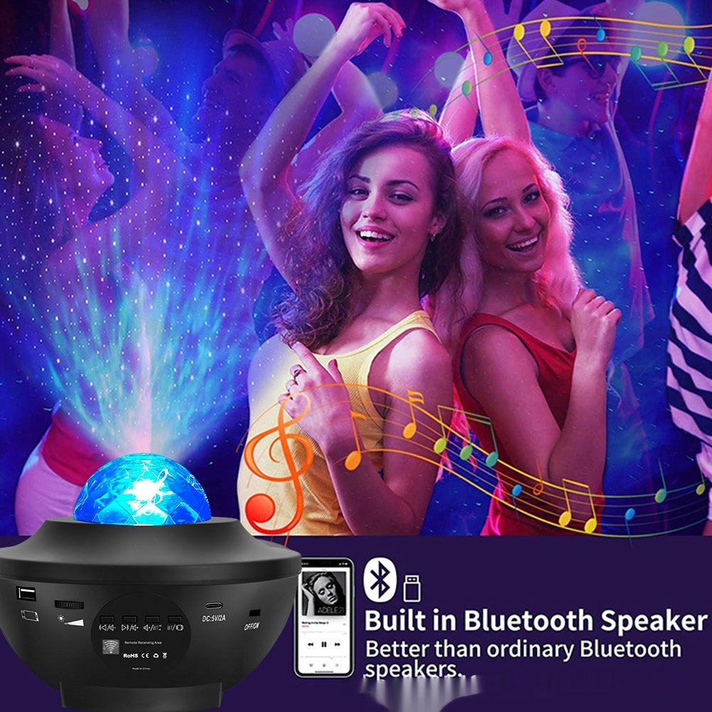 Two women dancing with a Bluetooth speaker and light projector in front of a colorful background.