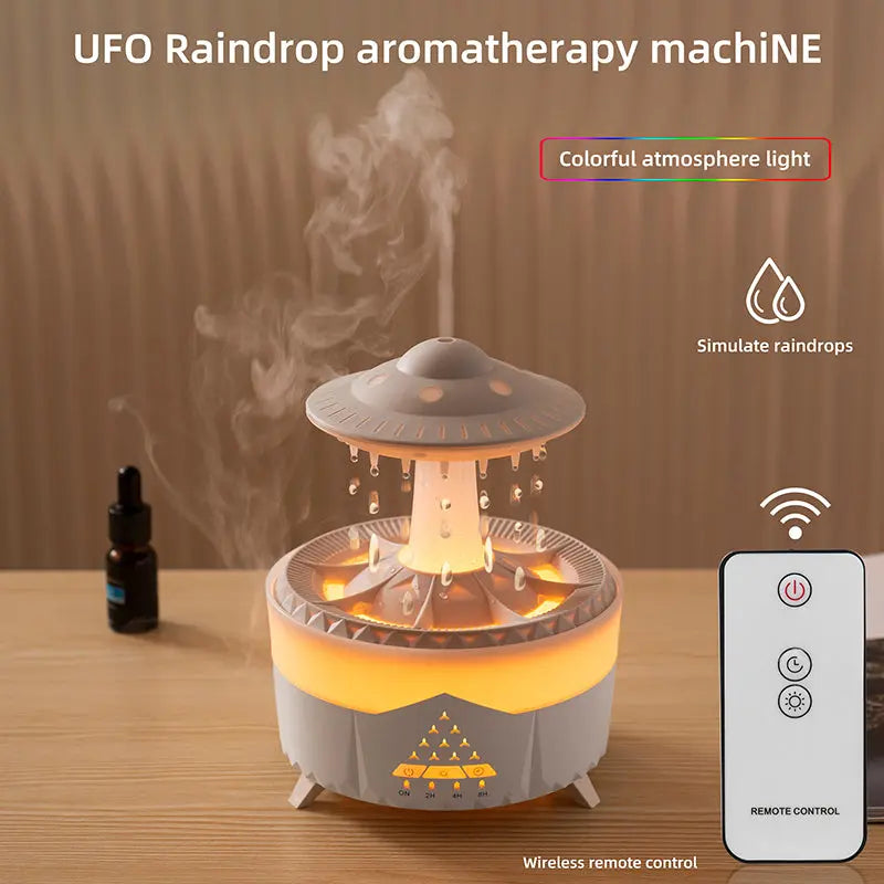 UFO raindrop aromatherapy machine with remote control on a wooden surface